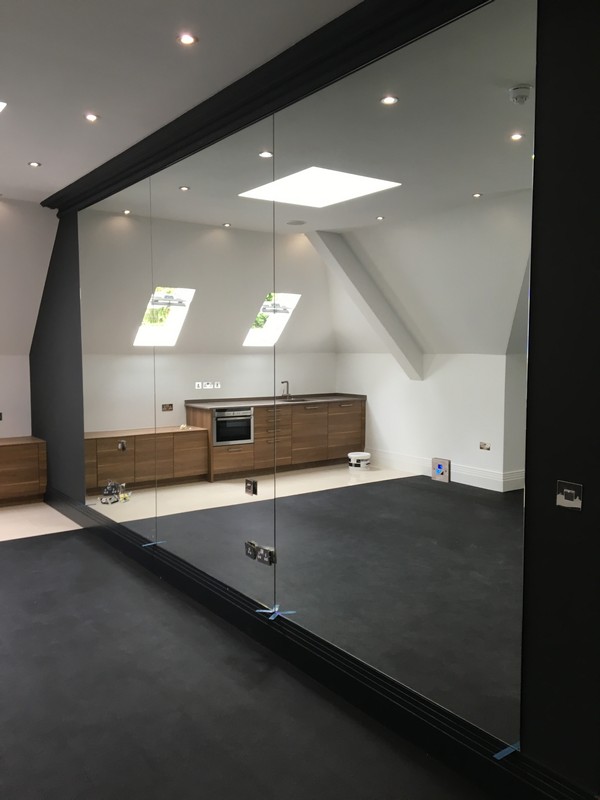 Frameless glass partition in loft conversion by Brixton glaziers