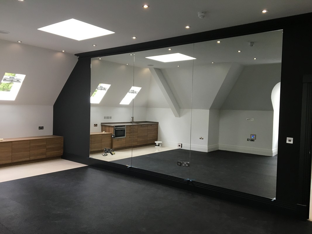 Frameless glass wall dividing loft conversion in Brixton
